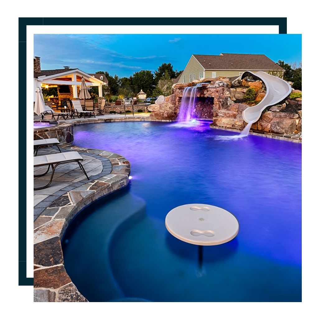 beautiful pool with waterfall lighting