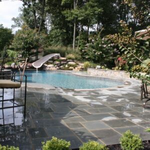 a stone patio around a pool