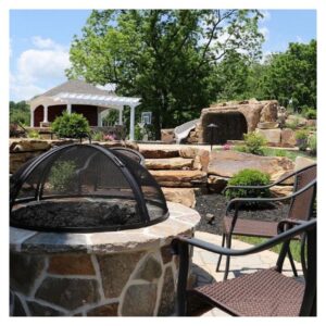 An image of a fire pit and several levels of patio and swimming pool areas. 